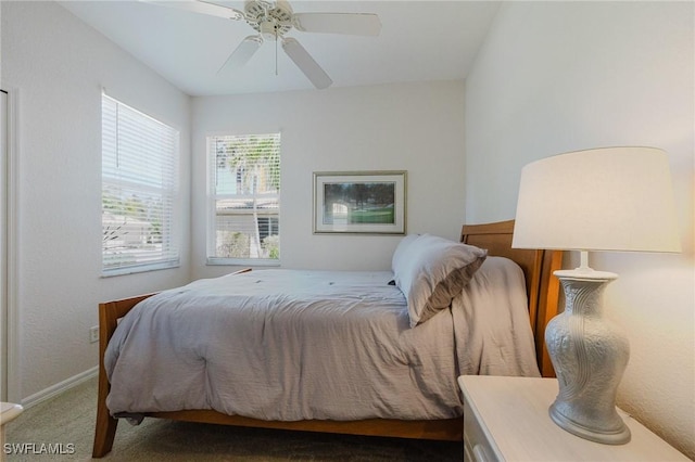 carpeted bedroom with a ceiling fan and baseboards