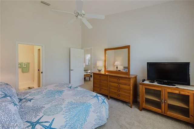 bedroom featuring visible vents, light carpet, high vaulted ceiling, connected bathroom, and ceiling fan