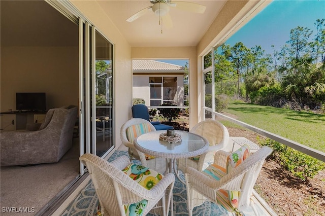 sunroom with a healthy amount of sunlight and ceiling fan