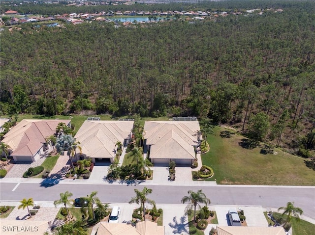 drone / aerial view featuring a view of trees and a water view