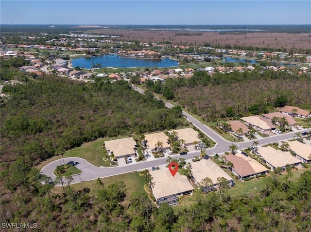 drone / aerial view featuring a water view and a residential view