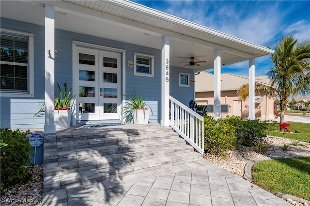 entrance to property featuring a porch and ceiling fan