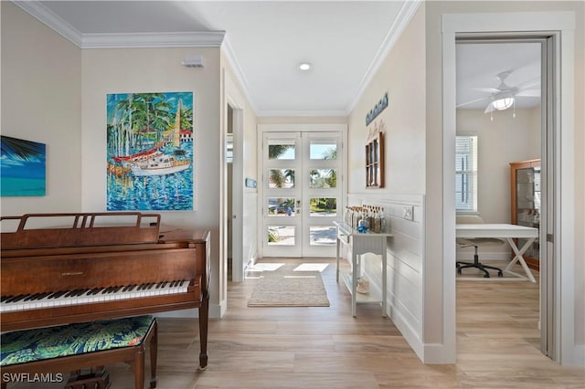 interior space with french doors, light wood-type flooring, and crown molding