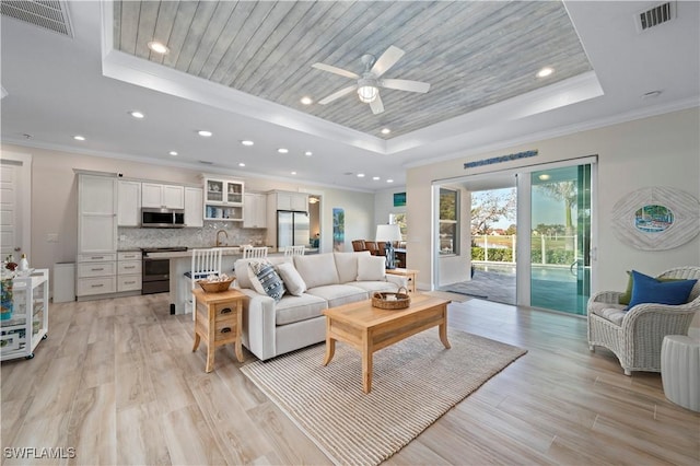 living room with visible vents, a raised ceiling, light wood-style floors, and wood ceiling