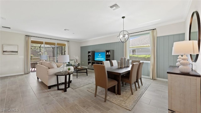 dining space featuring visible vents, crown molding, and baseboards