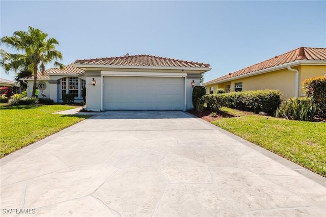 mediterranean / spanish-style house with a tile roof, a front lawn, and stucco siding