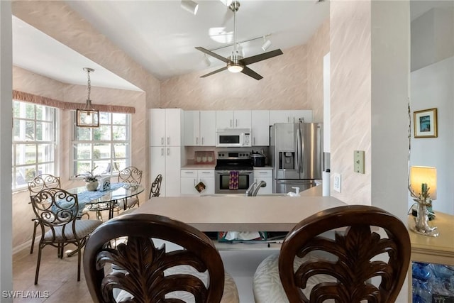 dining room featuring light tile patterned floors and a ceiling fan