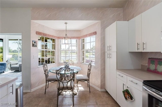 dining room with light tile patterned floors and baseboards