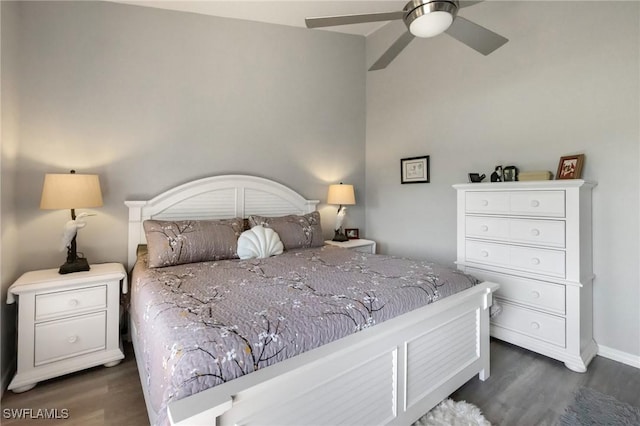 bedroom featuring baseboards, dark wood-type flooring, and a ceiling fan