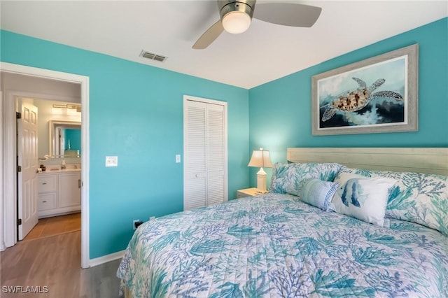 bedroom featuring visible vents, wood finished floors, a closet, baseboards, and ceiling fan