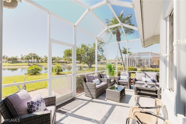 sunroom / solarium featuring a water view