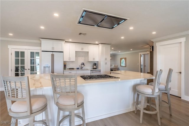 kitchen with visible vents, ornamental molding, white cabinetry, french doors, and white appliances