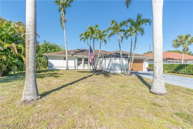 view of front of house with stucco siding, a front lawn, concrete driveway, an attached garage, and a lanai