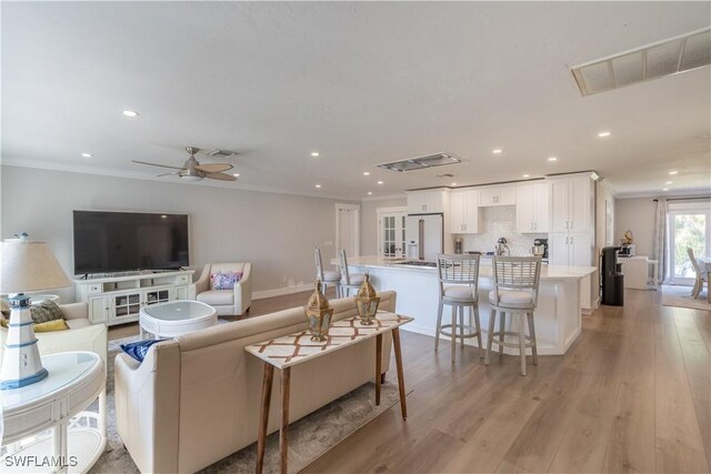 2237 Kings Lake Blvd, Naples, FL 34112 - living room featuring recessed lighting, ornamental molding, light wood-type flooring, ceiling fan, and baseboards
