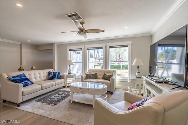 living area featuring a ceiling fan, wood finished floors, visible vents, recessed lighting, and ornamental molding