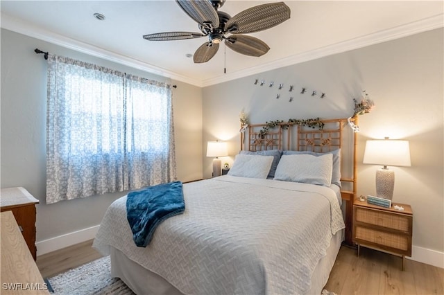 bedroom with baseboards, ornamental molding, a ceiling fan, and light wood finished floors