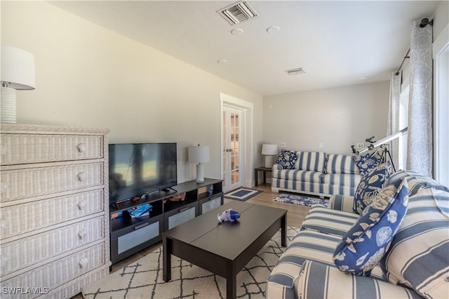 living room featuring visible vents and wood finished floors