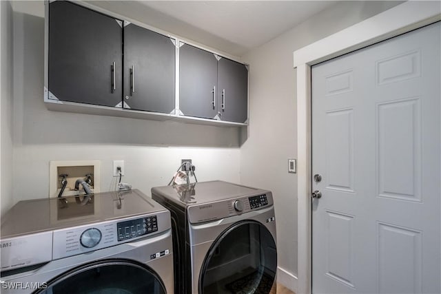 laundry area featuring washer and dryer and cabinet space