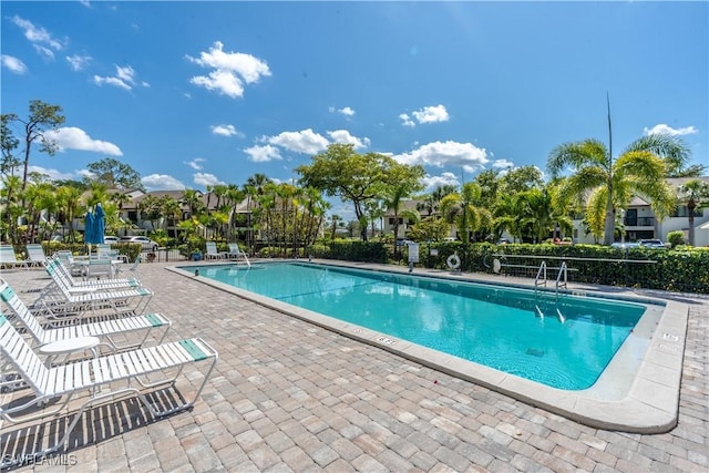 community pool with a patio area