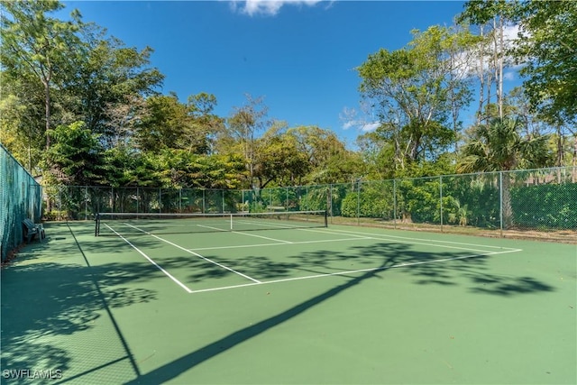 view of sport court featuring fence