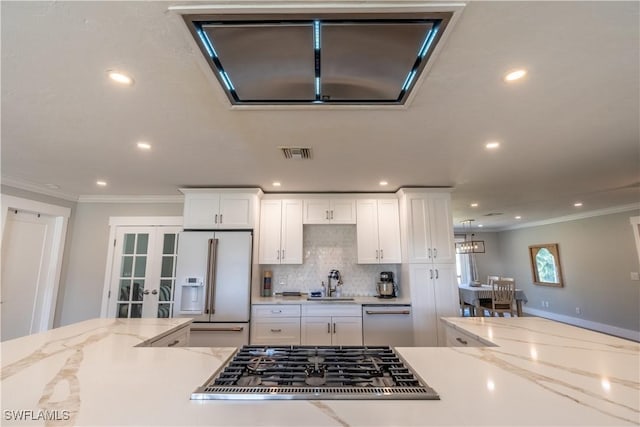 kitchen featuring visible vents, a sink, french doors, white appliances, and white cabinets