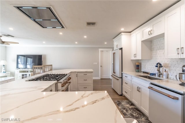 kitchen featuring tasteful backsplash, visible vents, white cabinets, white appliances, and a sink