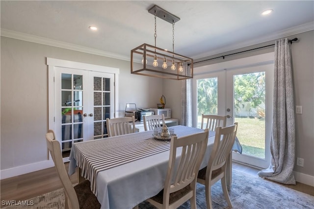 dining room featuring french doors, crown molding, baseboards, and wood finished floors