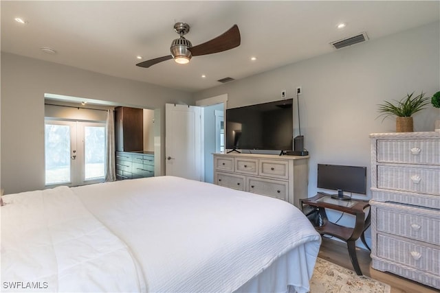 bedroom with visible vents, light wood-style floors, access to outside, and french doors