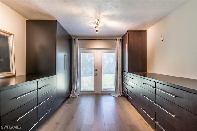 doorway featuring light wood-style flooring and french doors