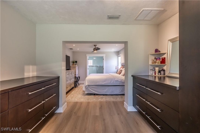 bedroom with visible vents, baseboards, and light wood-style floors