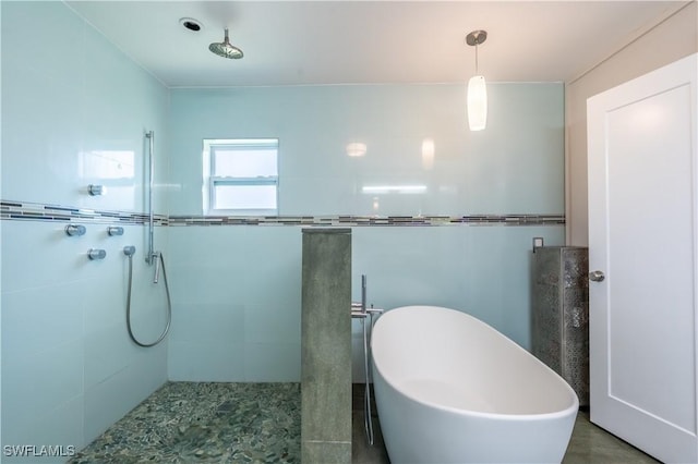 full bathroom featuring tile walls, a tile shower, and a freestanding bath