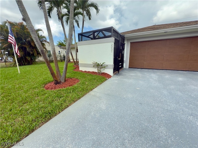 2237 Kings Lake Blvd, Naples, FL 34112 - view of front of house with a front lawn, driveway, an attached garage, and stucco siding