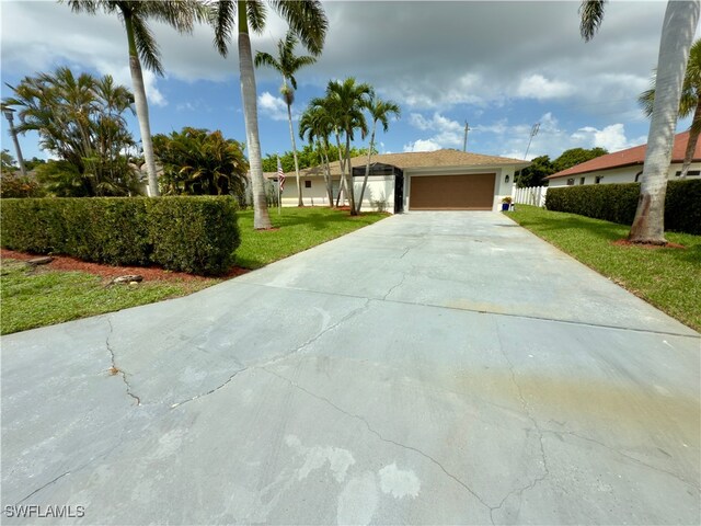 2237 Kings Lake Blvd, Naples, FL 34112 - ranch-style home with concrete driveway and a garage