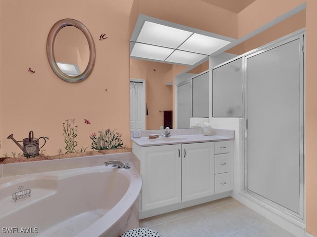 full bathroom with vanity, a garden tub, a shower stall, and tile patterned flooring