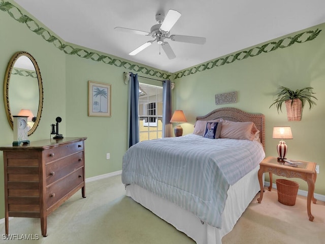 carpeted bedroom with baseboards and ceiling fan