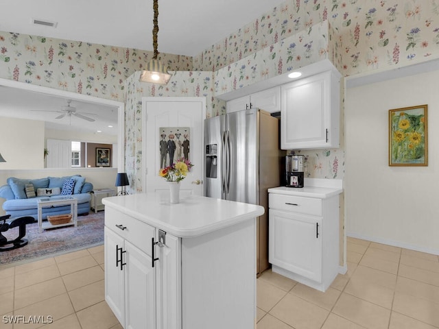 kitchen featuring visible vents, wallpapered walls, white cabinetry, light countertops, and light tile patterned floors