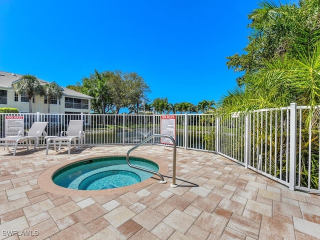 view of swimming pool with a patio and a hot tub