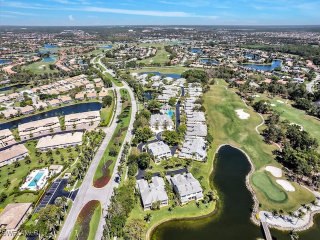 aerial view featuring golf course view, a water view, and a residential view