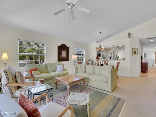 living area with a wealth of natural light, visible vents, light carpet, and vaulted ceiling