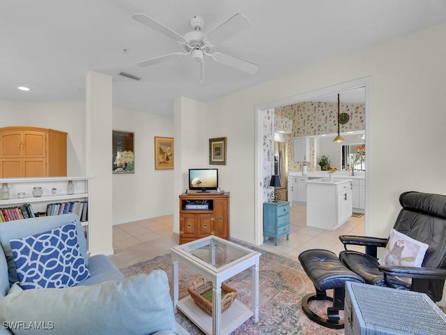 living room with light tile patterned floors, visible vents, and a ceiling fan