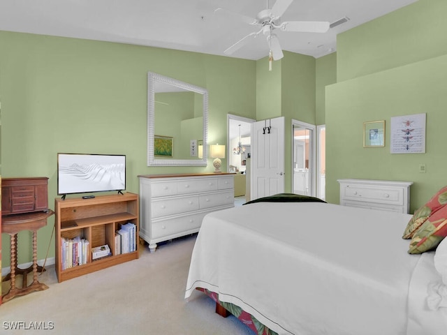 carpeted bedroom featuring high vaulted ceiling, visible vents, a ceiling fan, and ensuite bathroom