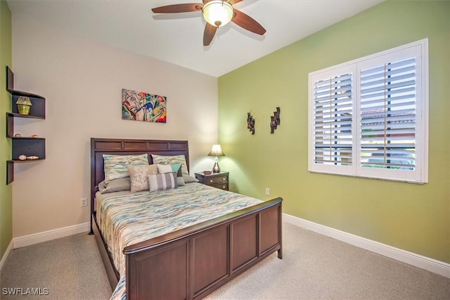 bedroom with ceiling fan, baseboards, and light carpet