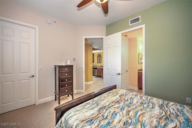 bedroom featuring visible vents, connected bathroom, ceiling fan, baseboards, and carpet floors