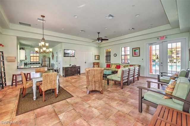 dining room with a tray ceiling, french doors, and visible vents