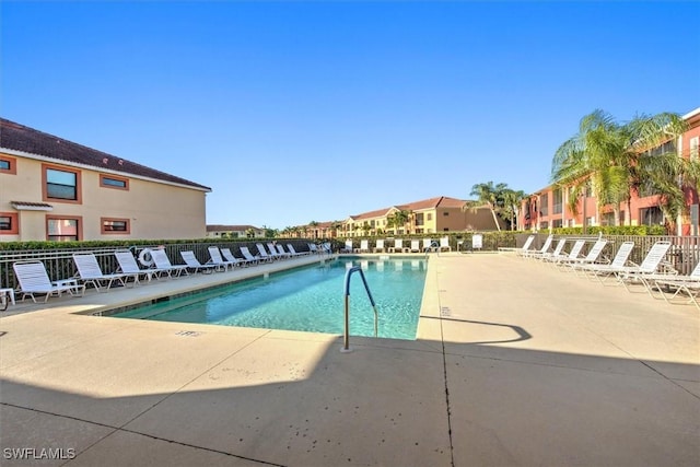 pool featuring a patio area and fence