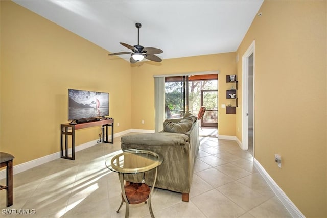 living area with light tile patterned floors, a ceiling fan, lofted ceiling, and baseboards