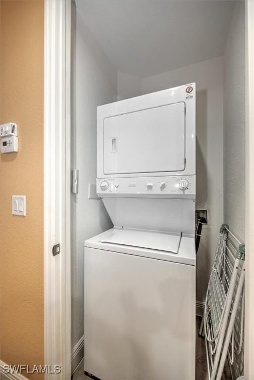 laundry area with laundry area and stacked washer / dryer