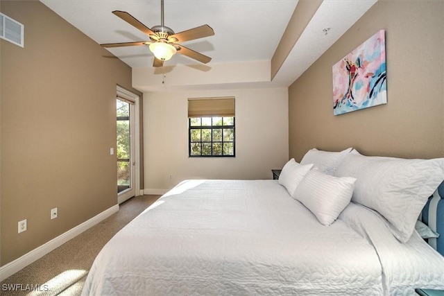 carpeted bedroom featuring access to exterior, baseboards, visible vents, and ceiling fan