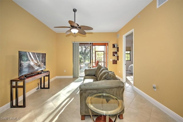 living room featuring light tile patterned floors, visible vents, ceiling fan, and baseboards