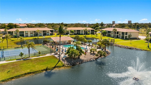 drone / aerial view with a water view and a residential view